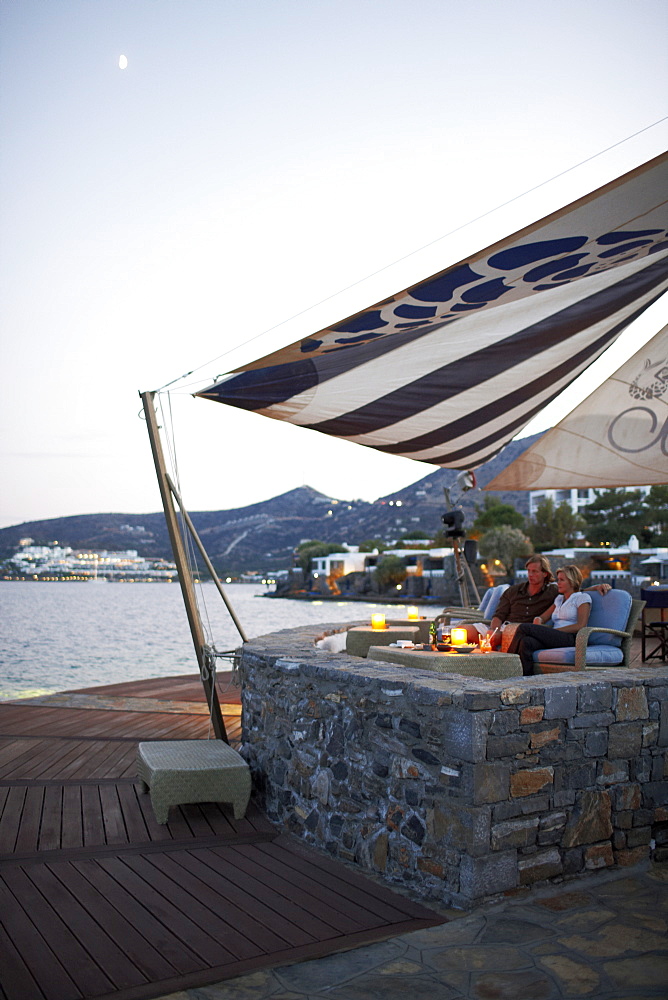 Couple having drinks at the Veghera Bar, Elounda Beach Resort, Elounda, Crete, Greece