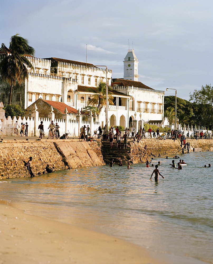 Kids bathing on Malindi beach, Mzingani Road, the shore of the Stone Town, tower of House of Wonders, Zanzibar Town, Zanzibar, Tanzania, East Africa