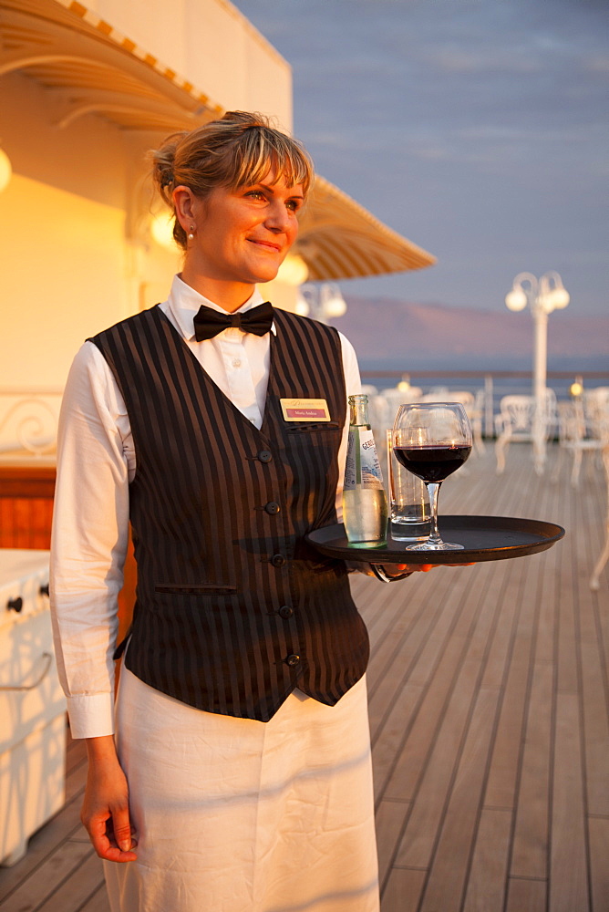 Golden waitress Maria aboard cruise ship MS Deutschland, Reederei Peter Deilmann, South Pacific Ocean, near Chile, South America