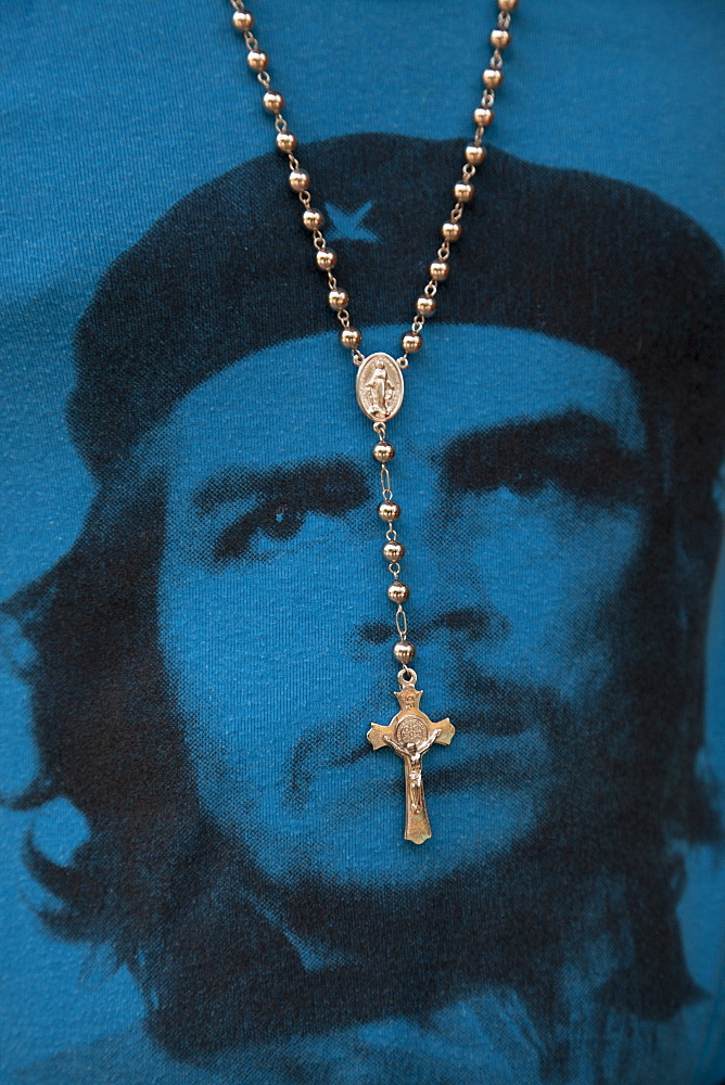 Cross hanging from the neck of man wearing a blue Che Guevara T-shirt, Havana, Havana, Cuba, Caribbean