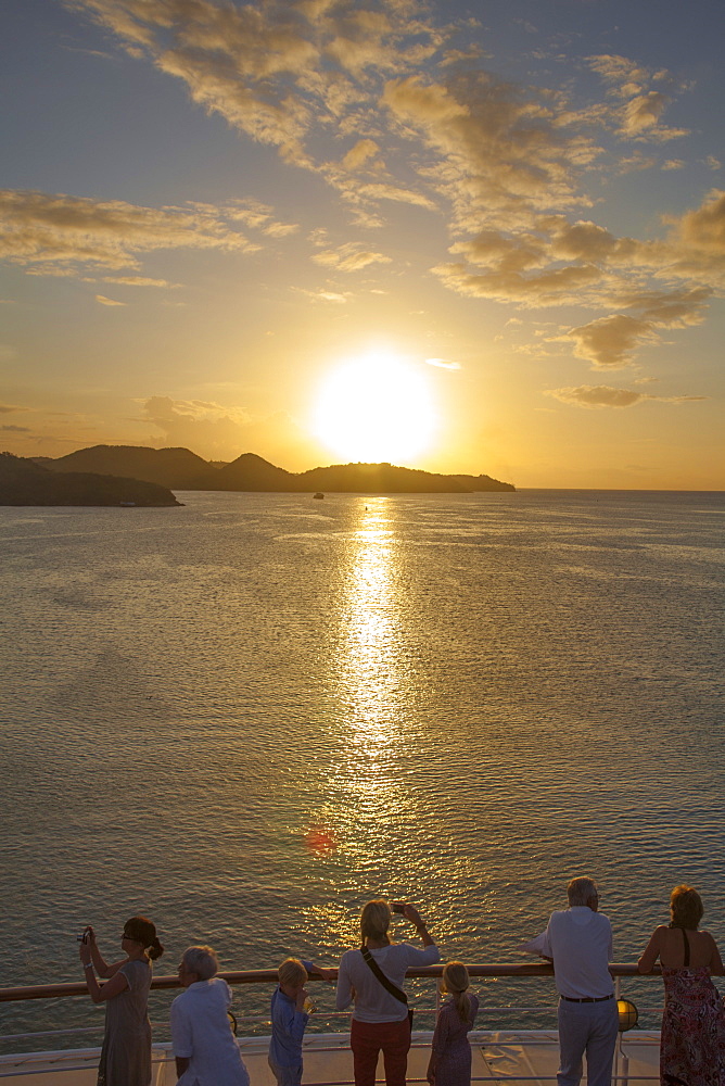 People standing at the railing of cruise ship MS Deutschland (Reederei Peter Deilmann) and admiring the sunset, near St. John's, St. John, Antigua, Antigua and Barbuda, Caribbean