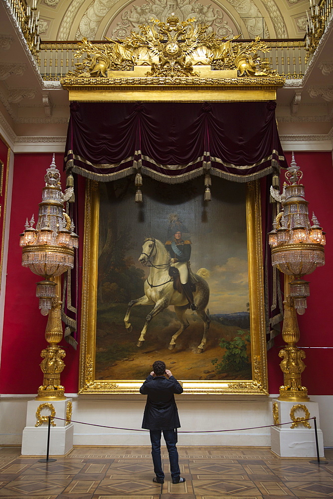 Man photographing painting inside The Hermitage museum complex, St. Petersburg, Russia, Europe