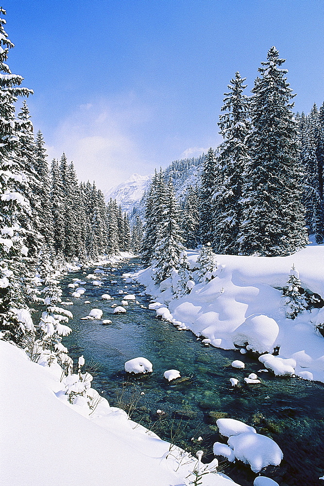 A river flowing through a Winter Landscape, near Arlberg, Tyrol, Austria