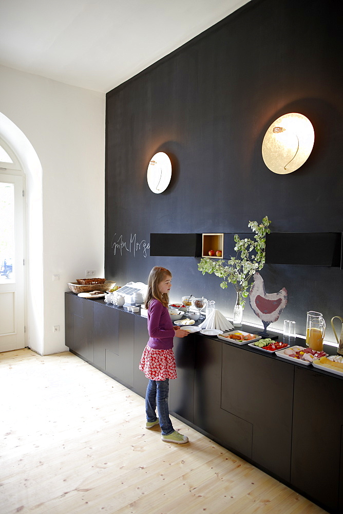 Girl in a hotel breakfast room, Fincken, Mecklenburg-Western Pomerania, Germany