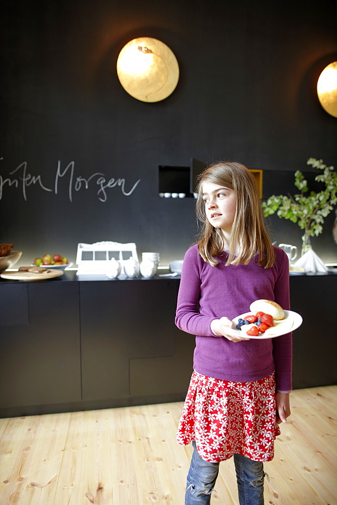 Girl in a hotel breakfast room, Fincken, Mecklenburg-Western Pomerania, Germany