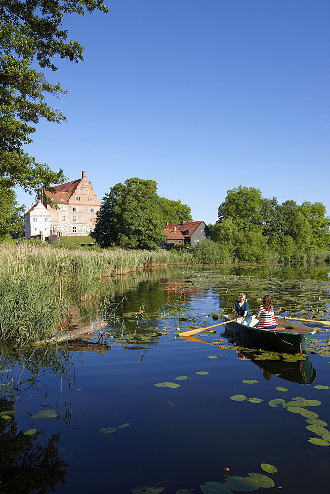 Two women in a rowing boat on lake Ulrichshusen, Ulrichshusen castle, Mecklenburg-West Pomerania, Germany