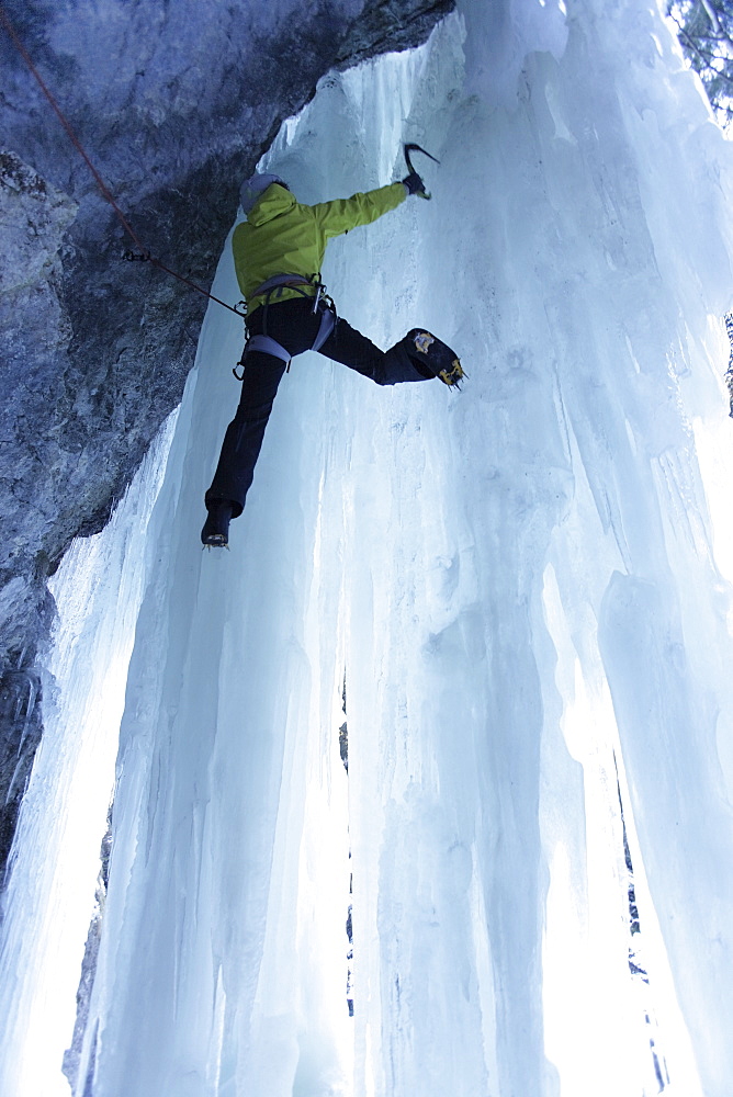 Iceclimber climbing on an ice face, Immenstadt, Bavaria, Germany