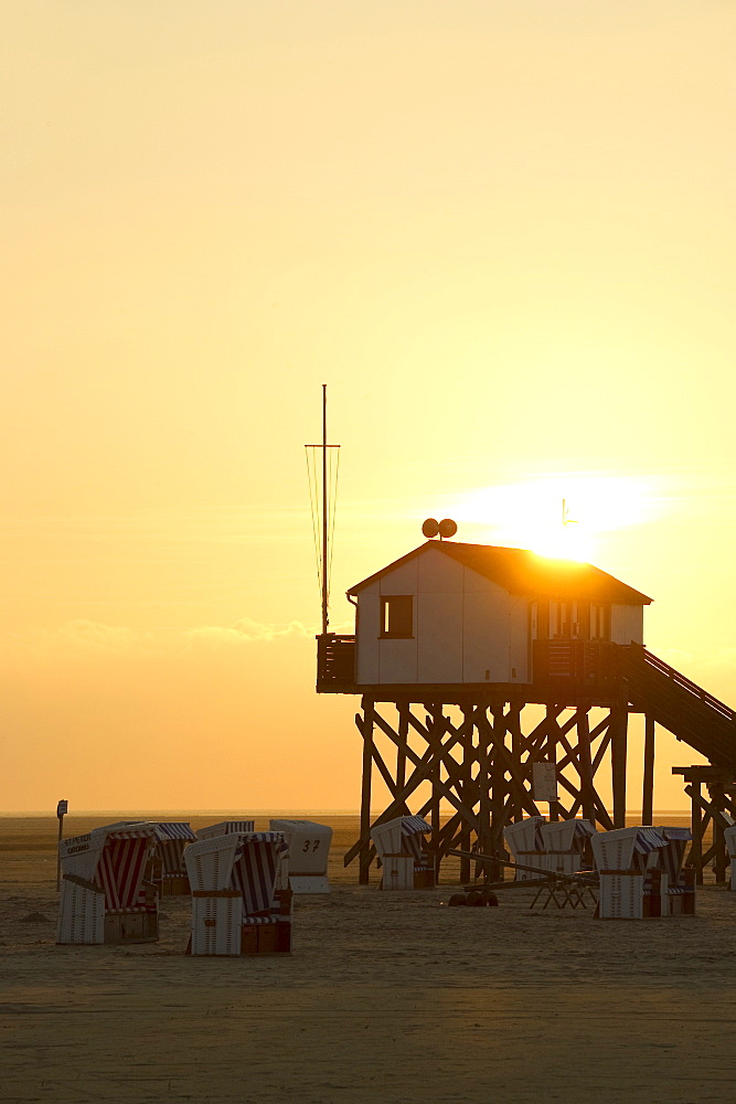 Stilt house on the beach at sunset, Sankt Peter-Ording, Wadden Sea National Park, Eiderstedt peninsula, North Frisian Islands, Schleswig-Holstein, Germany, Europe