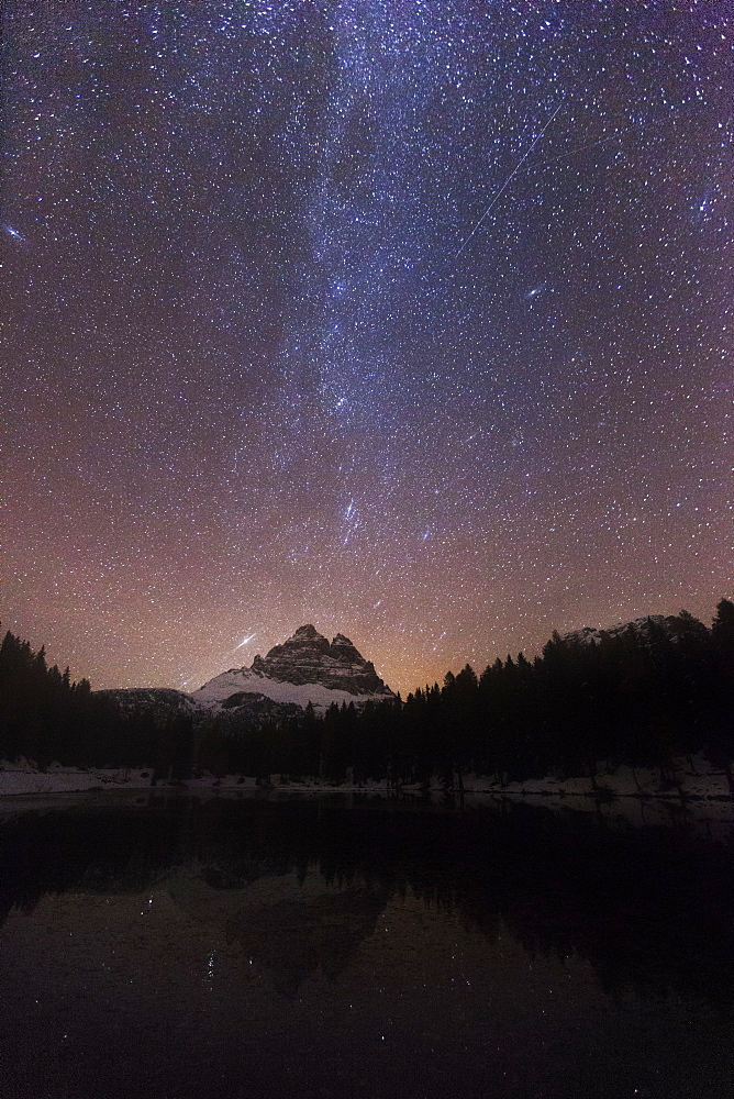 Impressive night sky with the Milky Way over Lago de Antorno and view towards the Tre Cime di Lavaredo from the South-west, South Tyrol, Italy