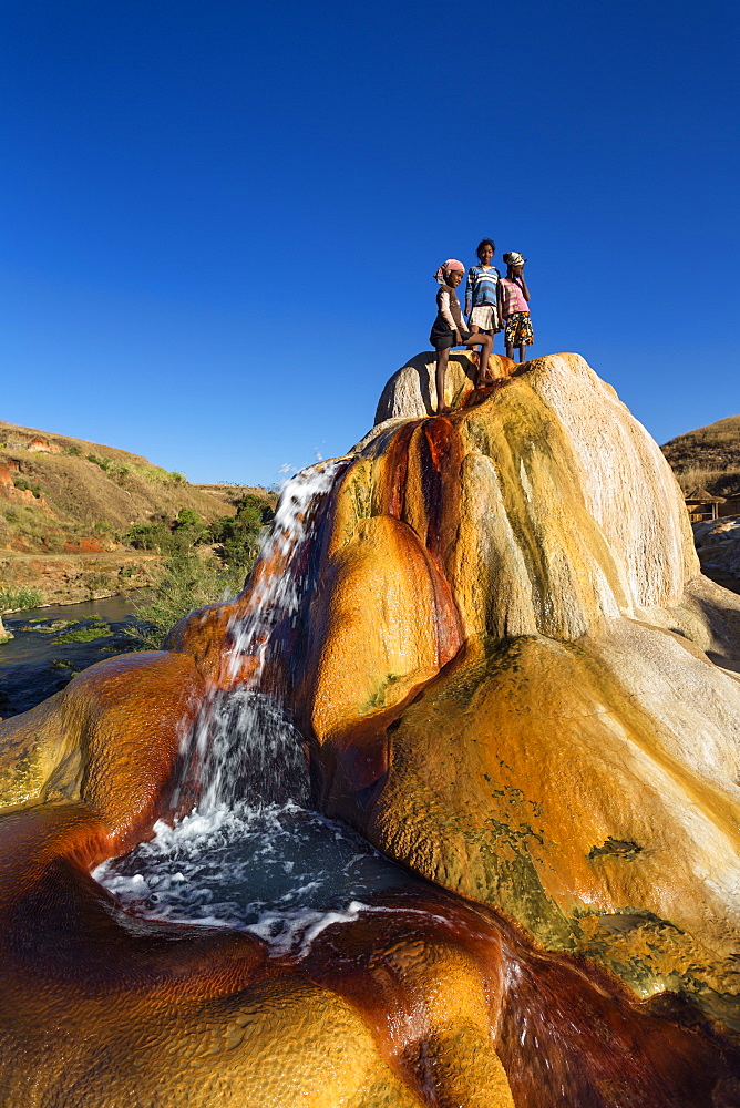 Madagascan children playing in a spouting Geyser, Geysers of Ampefy, highlands, Madagascar, Africa