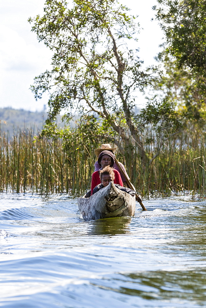 Family in dug out canoe, Canal de Pangalanes, East Madagascar, Africa