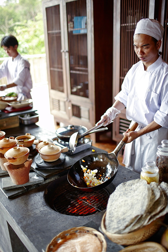 Chefs cooking in open kitchen of a hotel, Dat Doc Beach, Con Dao Island, Con Dao National Park, Ba Ria-Vung Tau Province, Vietnam