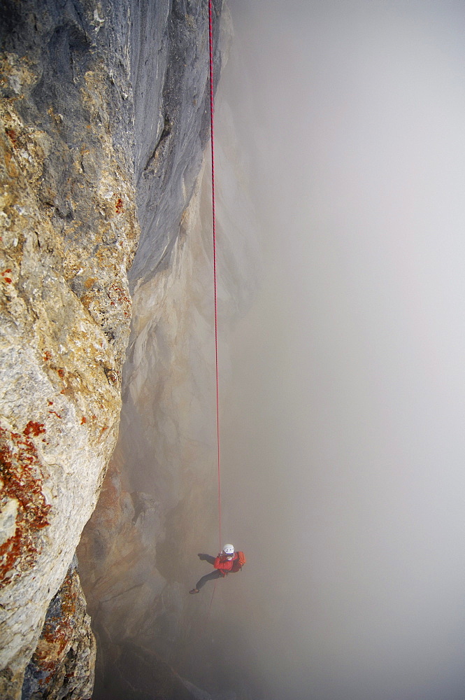 Climber roping in the fog, Tyrol, Austria, Europe