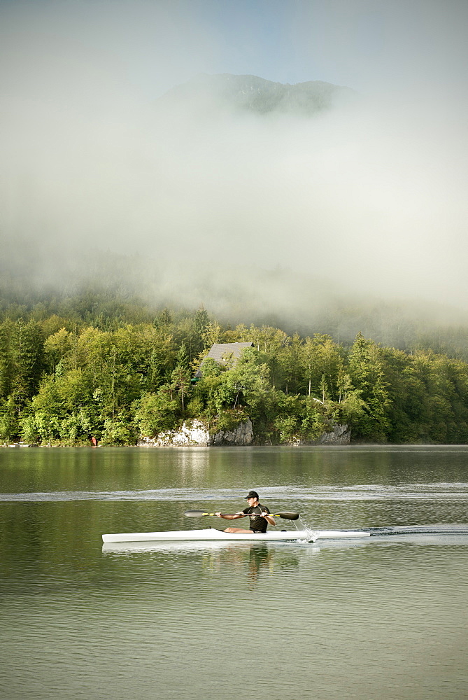 Kayak oarsman at Lake Bohinj, mist, Triglav National Park, Julian Alps, Gorenjska, Slovenia