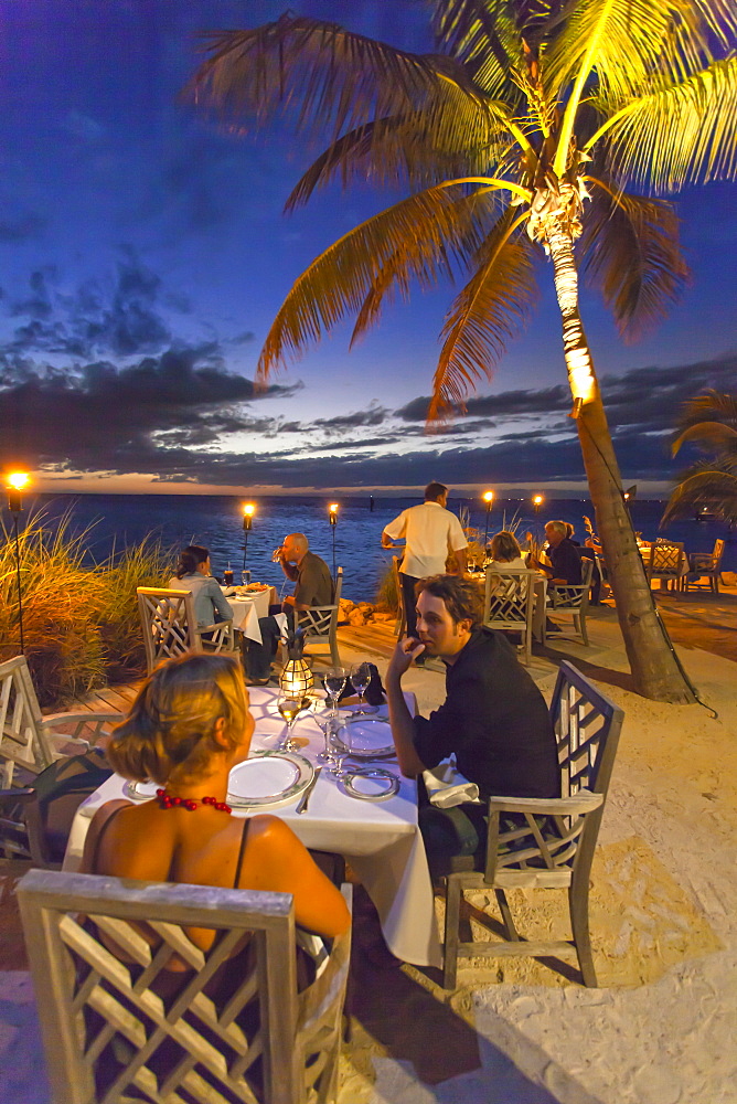 Dining couple at Restaurant DINING ROOM at sunset, Little Palm Island Resort, Florida Keys, USA