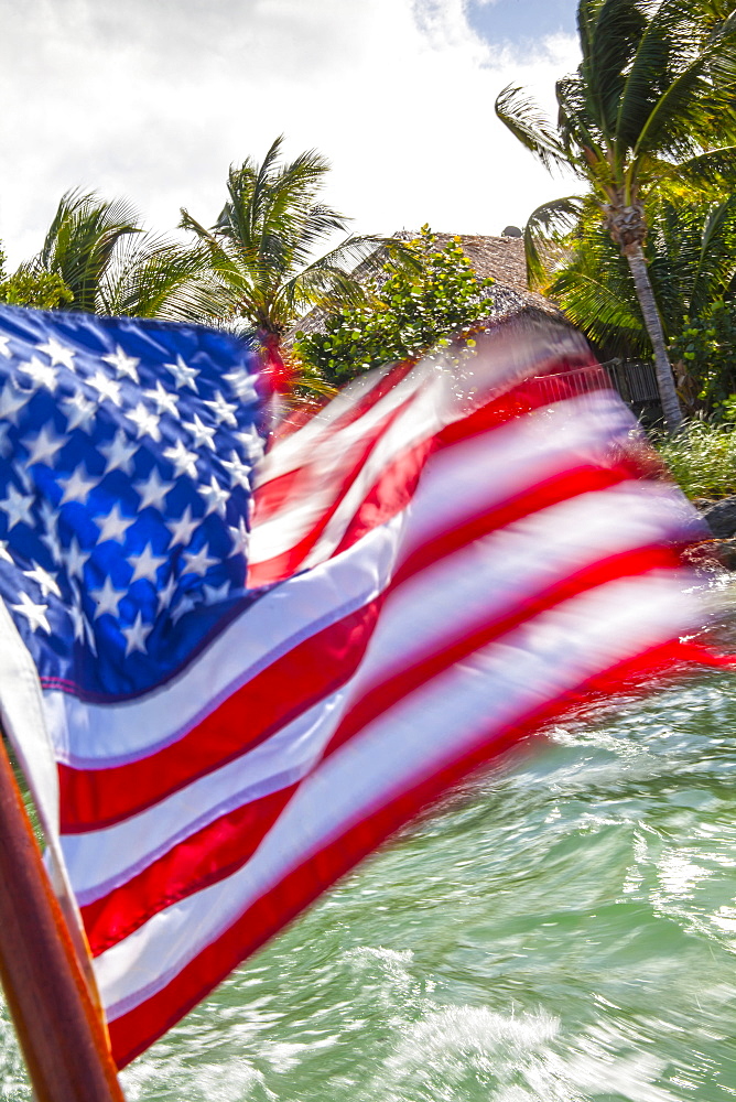 US Flag on a boat leaving Little Palm Island, Little Palm Island Resort, Florida Keys, USA
