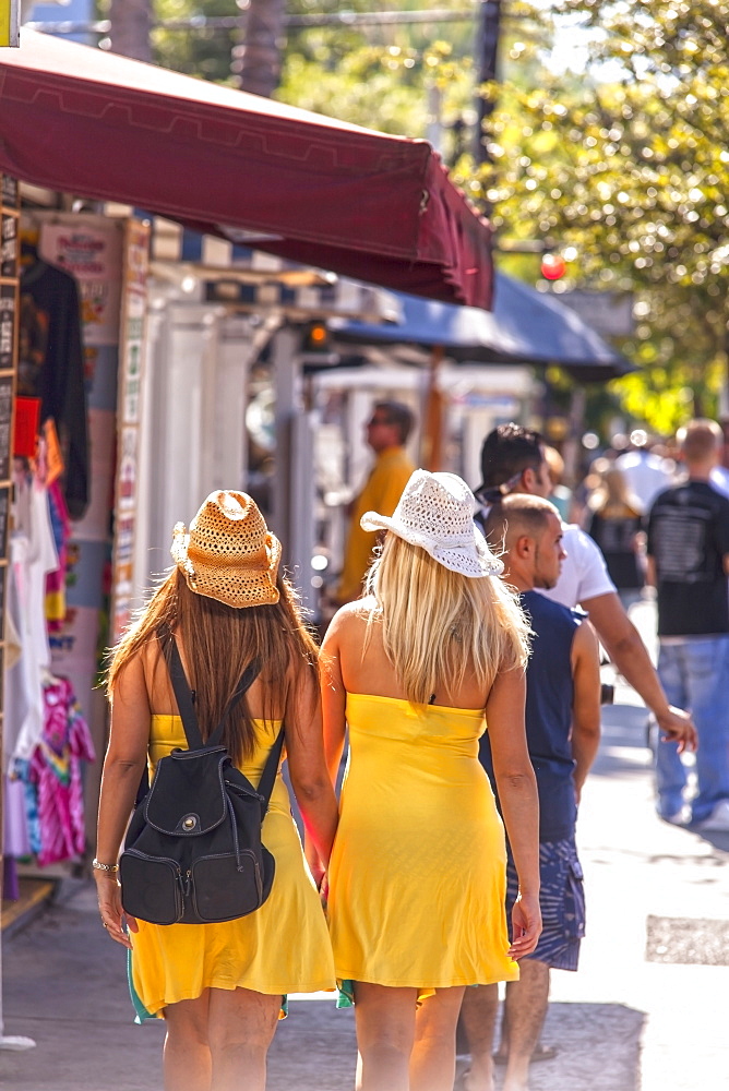 Two young women shopping on Duval Street, Key West, Florida Keys, Florida, USA