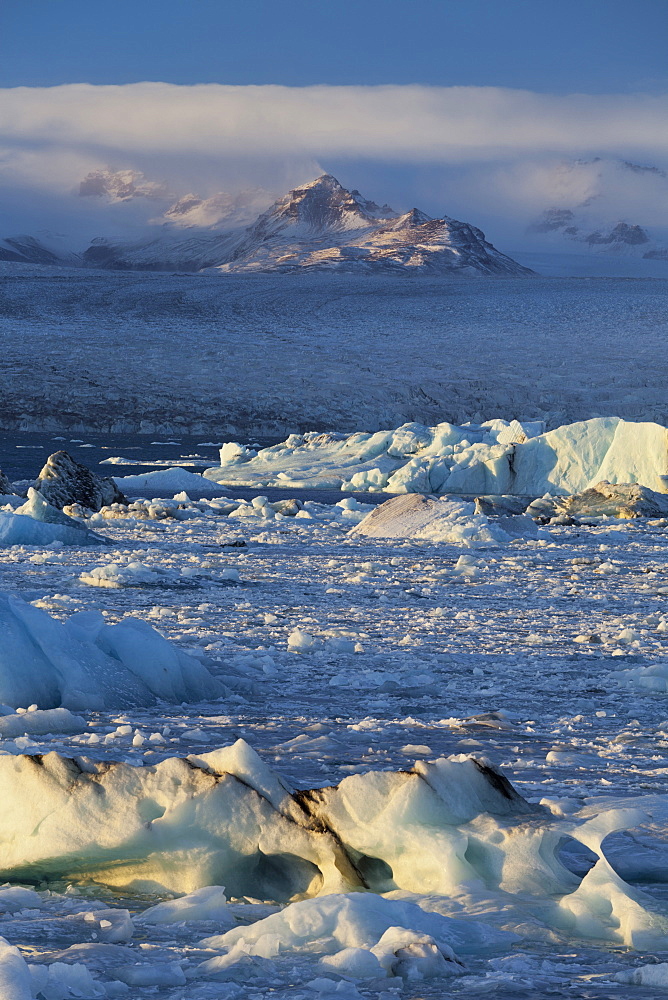 Icebergs in the waves in the glacial lake, Jokulsarlon, East Iceland, Iceland