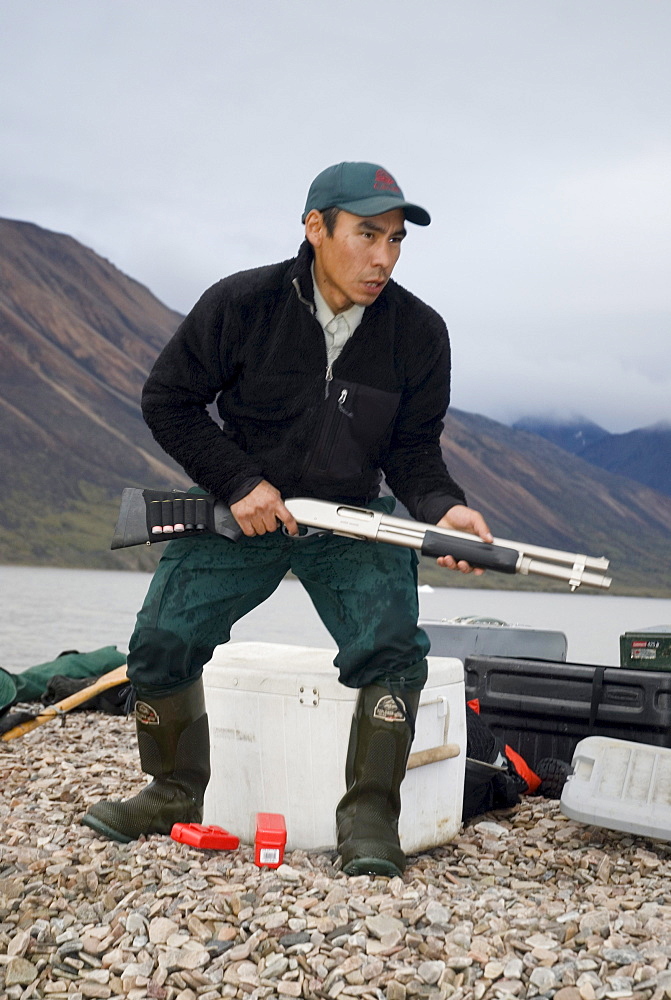 Parks guide with rifle, Sirmilik National Park, Bylot Island, Nunavut, Canada