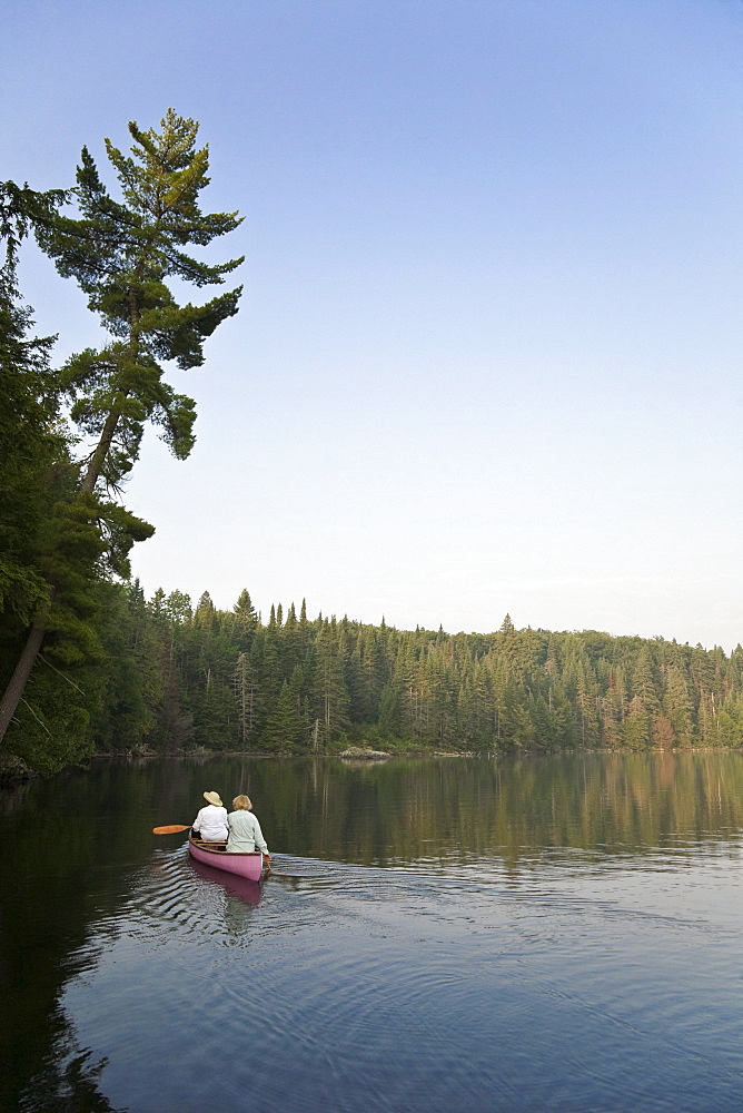 Canoeists paddling, Smoke lake, Algonquin Park, Ontario