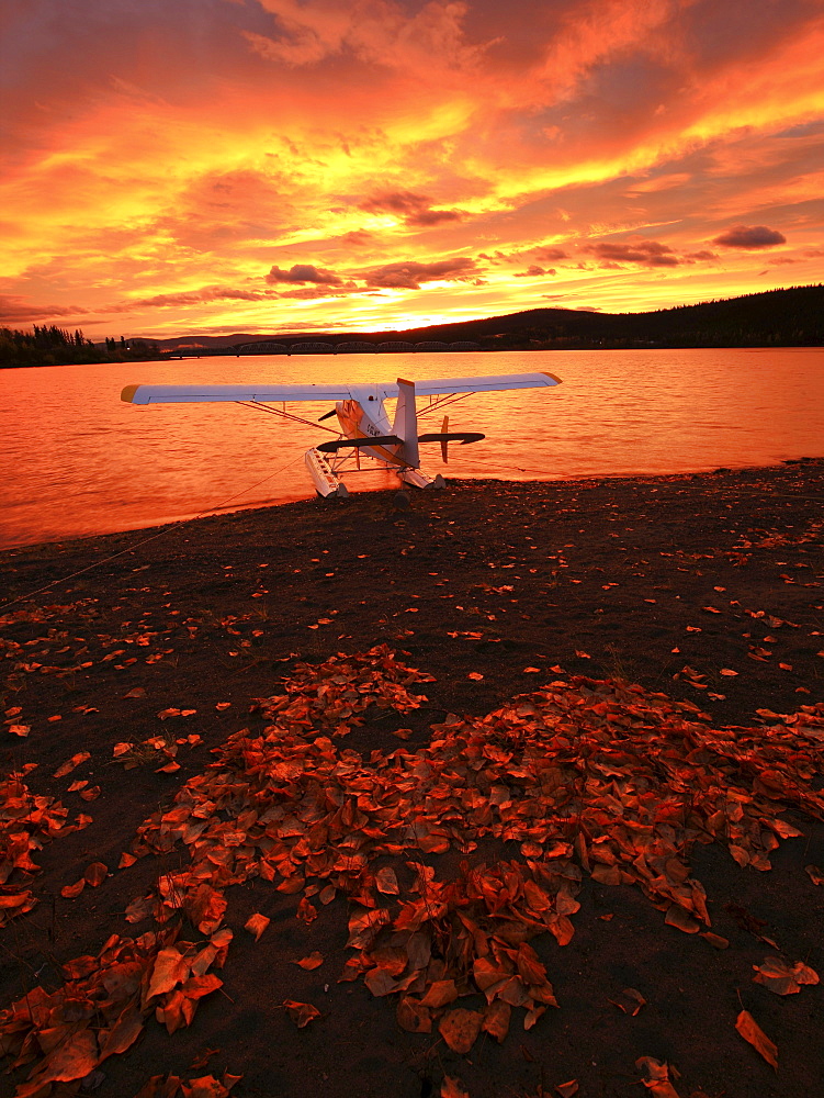 A float plane facing the sunrise over Teslin Lake, Yukon