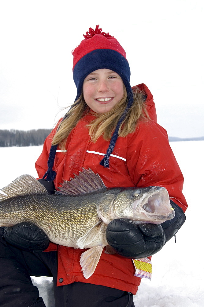 Young Girl Ice Fishing holding a Walleye, Wawa, Ontario