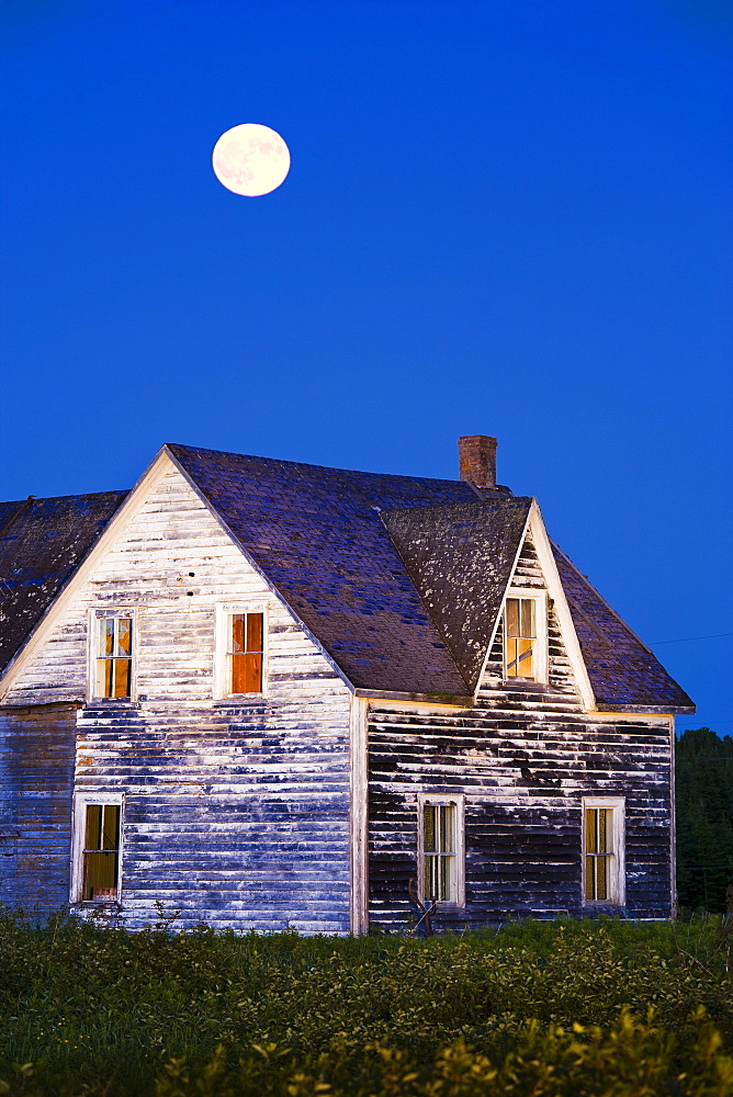 Abandoned house and moon at dusk, Perce, Gaspesie, Quebec