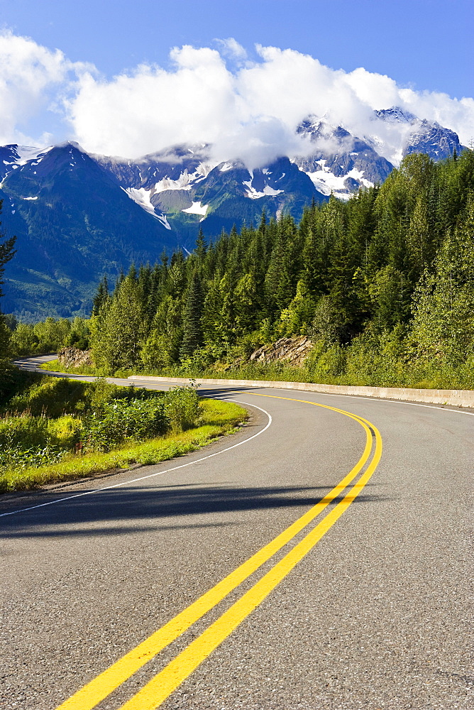 Road curving through mountain landscape, Highway 37A, Northern British Columbia