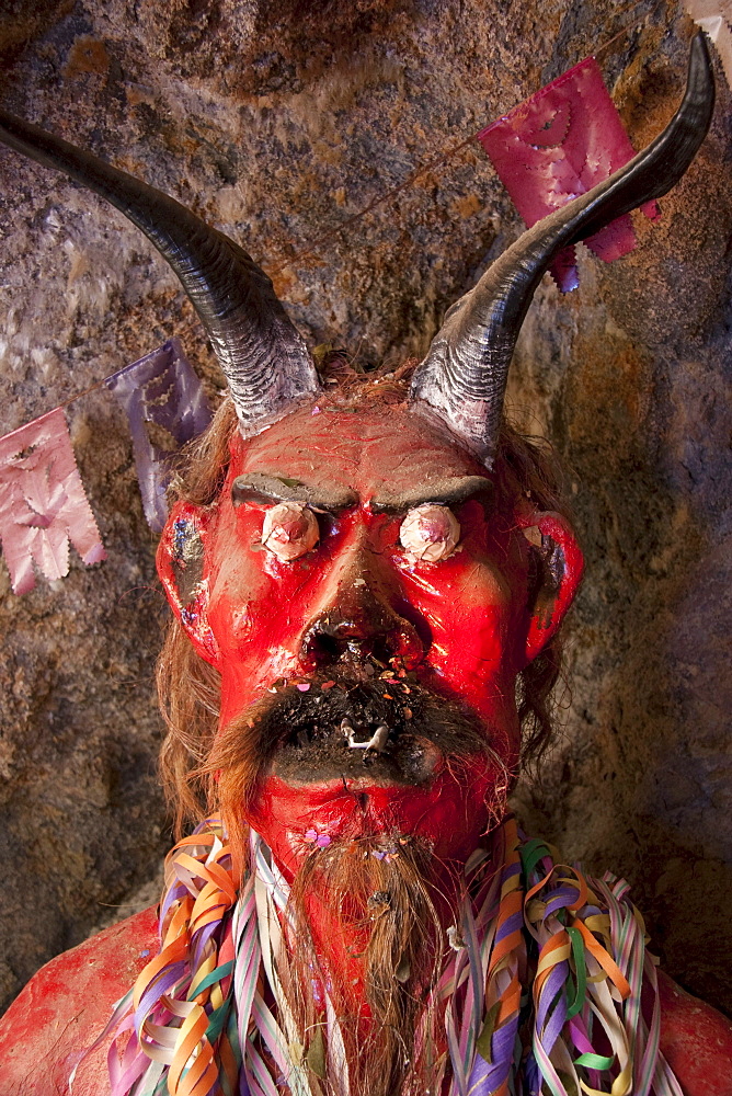 Ceramic figure of el Tio or Supai, a creature with horns, gleaming eyes and a big penis, that in fact is not really satanic. It was introduced by the Spaniards in the 16th Century to the mines of Potosi. According to tradition, el Tio (The Uncle) rules over the mines of Cerro Rico, simultaneously offering protection and destruction. Over 500 chambers with statues to honour him have been constructed in Cerro Rico, so miners can leave offerings of tobacco, liquor and coca leaves to invoke his goodwill and protection., Potosi Department, Bolivia