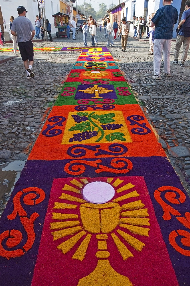 Carpet made of sand & sawdust along the Good Friday processional route. Carpet-making is thought of as a sacrificial act, as the elaborate detail and time that go into the carpet making is a way for people to give something of themselves in memory of the crucifixion of Jesus. These carpets last on average 2 hours before they are destroyed by the many feet that march over them during a procession in Antigua Guatemala., Sacatepuquez, Guatemala