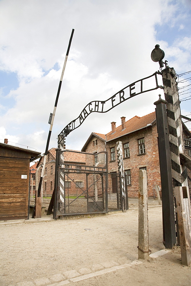 Main gate with the 'Arbeit macht frei' slogan over it, Auschwitz Concentration Camp, Oswiecim, Malopolska, Poland