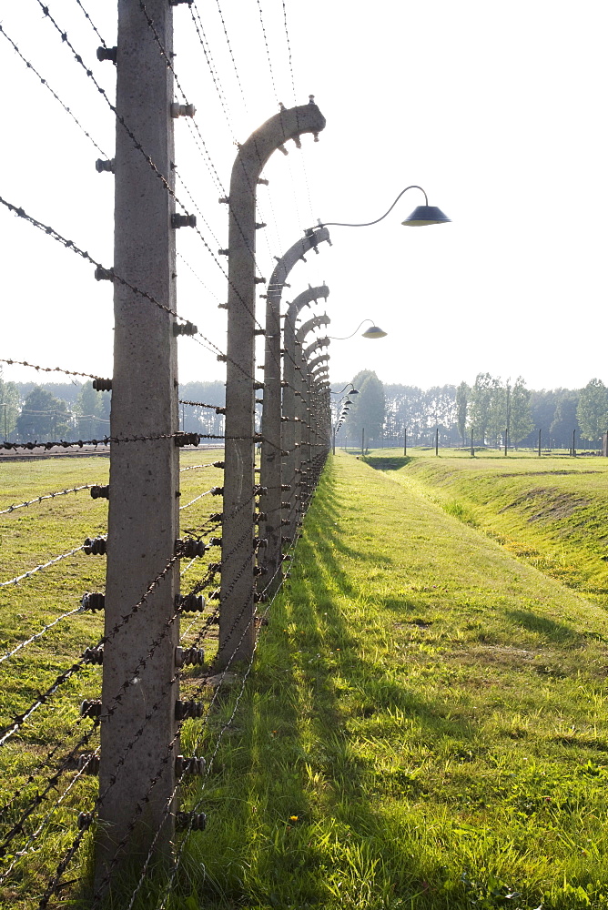 Electrified barbed wire fence separating sections of the Auschwitz-Birkenau Concentration Camp, Oswiecim, Malopolska, Poland