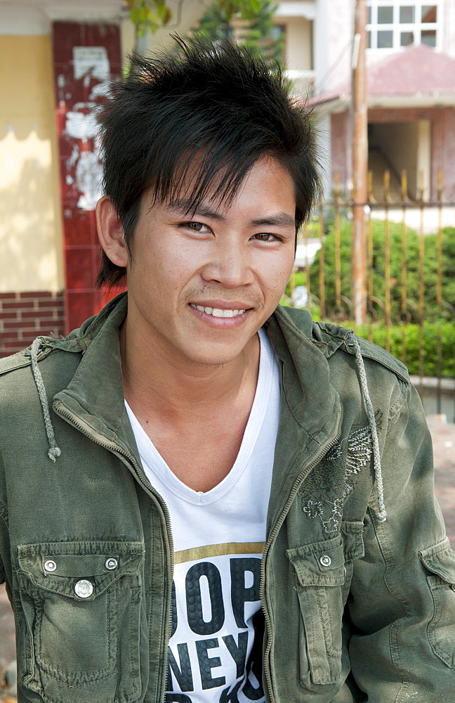 South East Asia, Vietnam, Hanoi, Student relaxes on his college campus for his portrait.