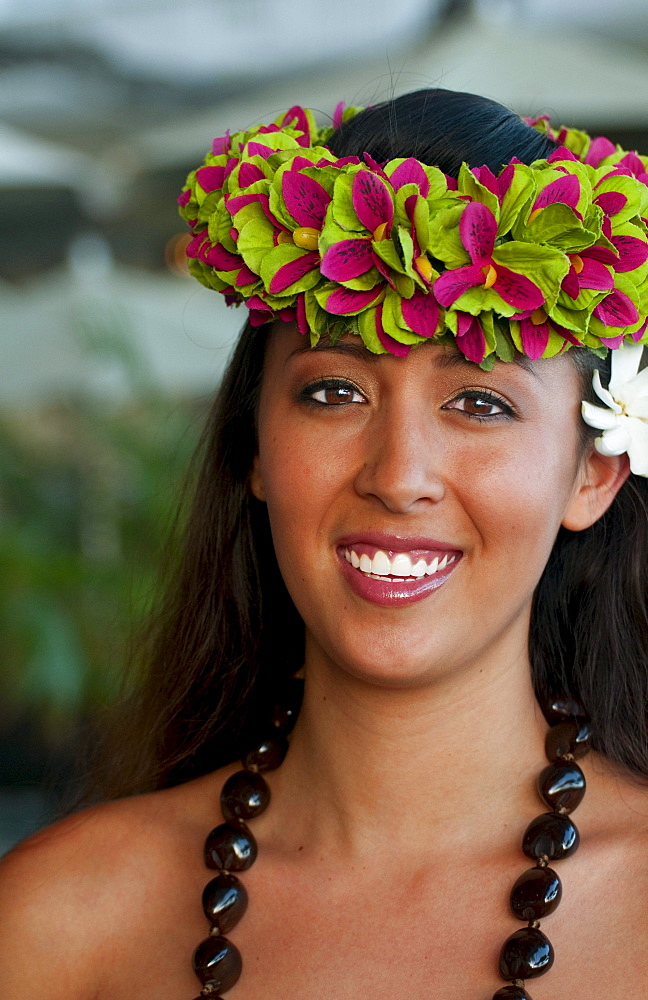 French Polynesia, Tahiti, Bora Bora, A local woman smiles in her floral headpiece.