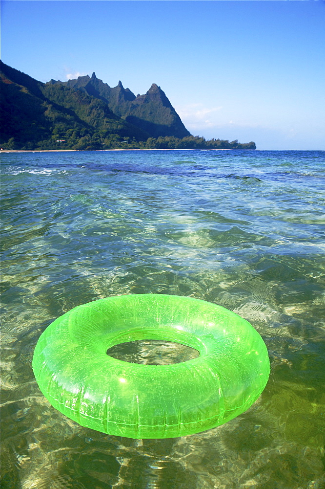 Hawaii, Kauai, Tunnels beach, Green innertube on the water.