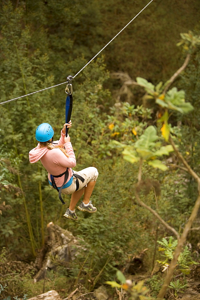 Hawaii, Maui, Zipline Adventure, Woman riding the zipline.