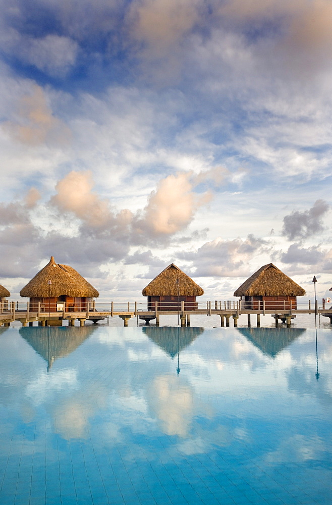 French Polynesia, Pearl Resort, Bungalows over beautiful turquoise ocean.