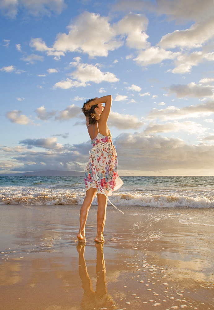 Hawaii, Maui, Woman standing on the shore of remote tropical location.