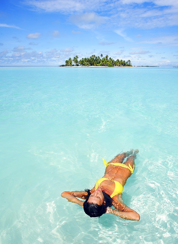 French Polynesia, Tahiti, Moorea, Woman floating in water.