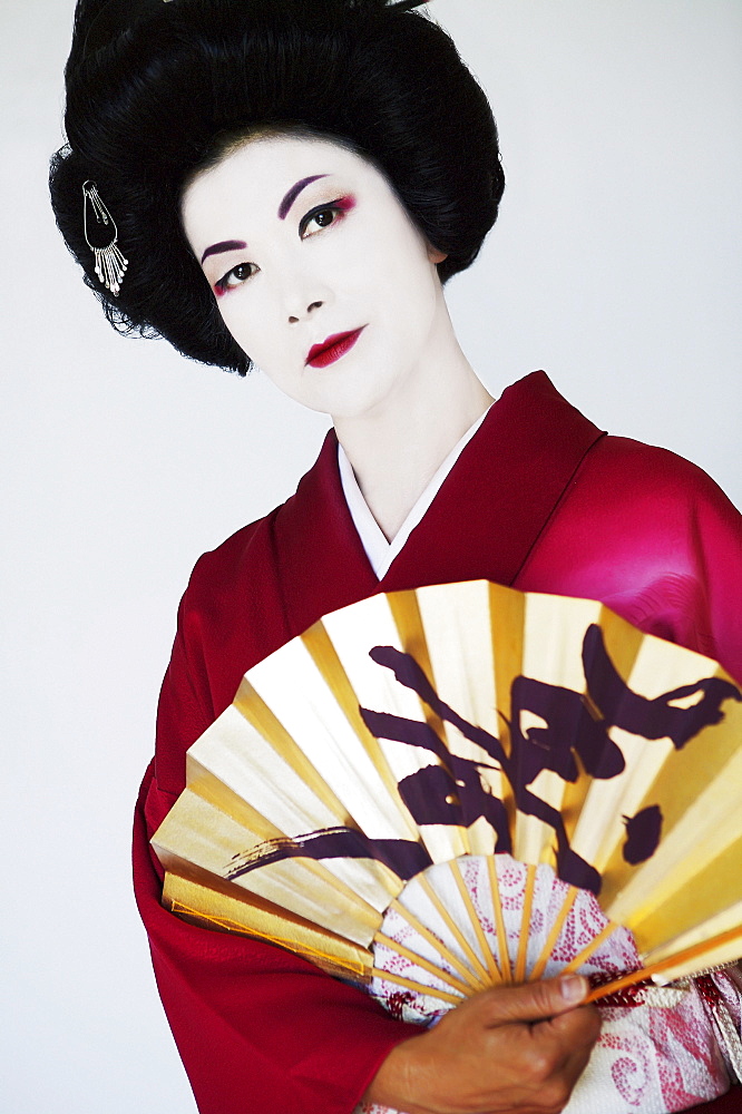 Traditional portrait of a Geisha with Japenese fan.