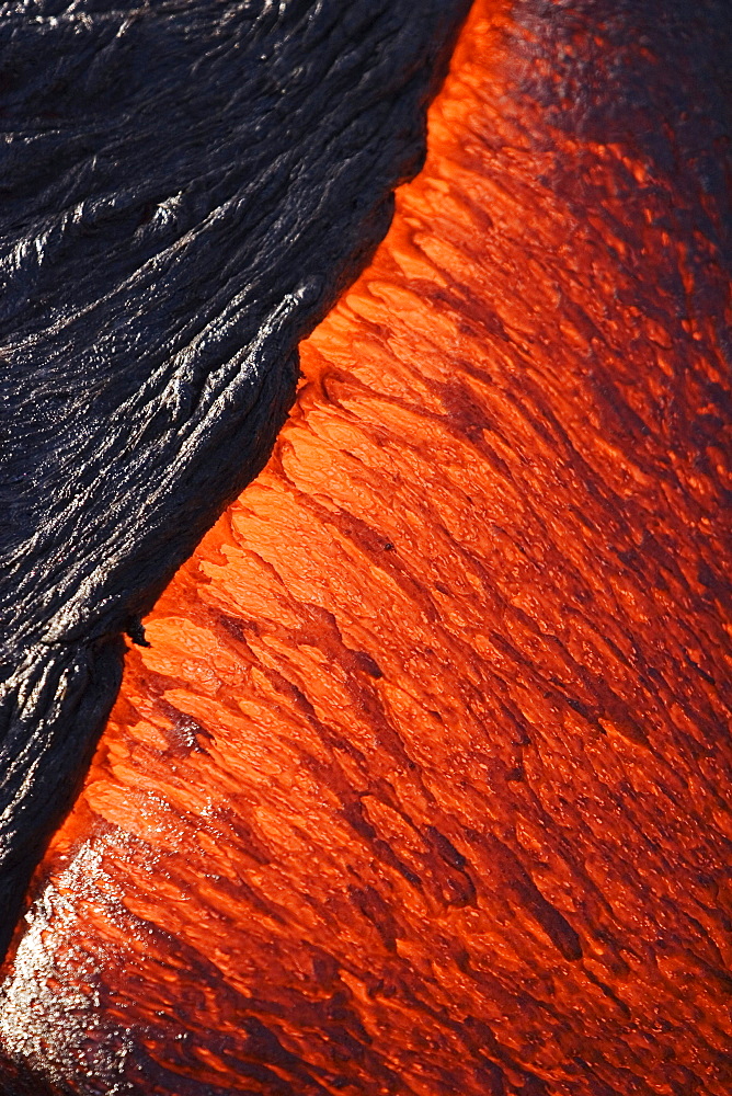 Hawaii, Big Island, Hawaii Volcanoes National Park, Kilauea Volcano, Detail of molten pahoehoe lava flowing downward.