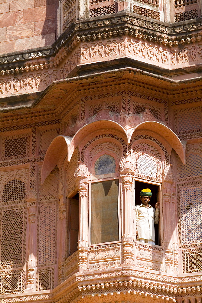 India, Rajasthan, Jodhpur, Fort Mehrangarh, man in window of Fort Palace.