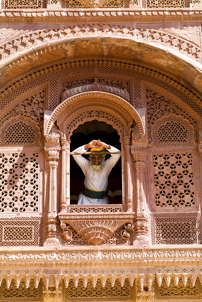 India, Rajasthan, Jodhpur, Fort Mehrangarh, man in window of Fort Palace.