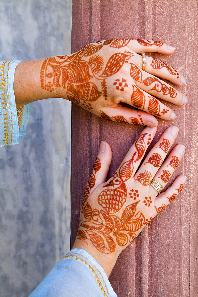 India, Delhi, Colorful Henna design on womans hands.