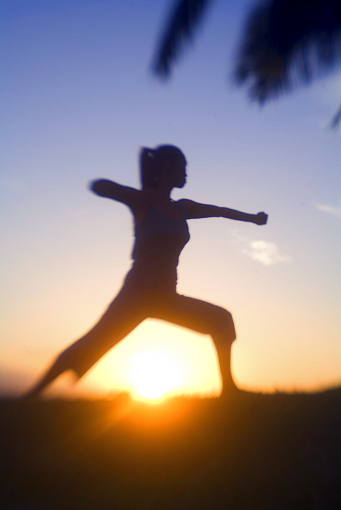 Hawaii, Maui, Olowalu, woman doing yoga at sunset.