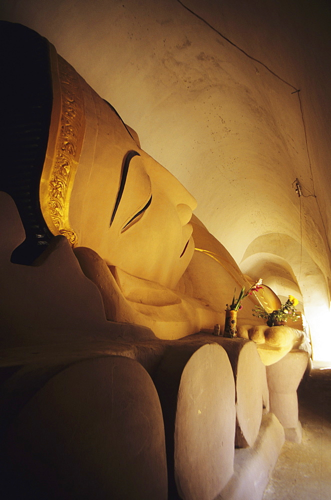 Burma (Myanmar), Bagan, Manuha Paya, angled close-up view of reclining Buddha.