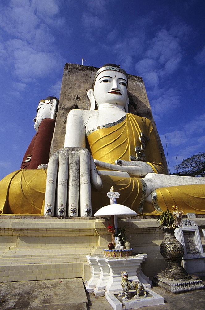 Burma (Myanmar), Bago, Kyaik Pun Paya, large Budhha statues, altar in foreground.