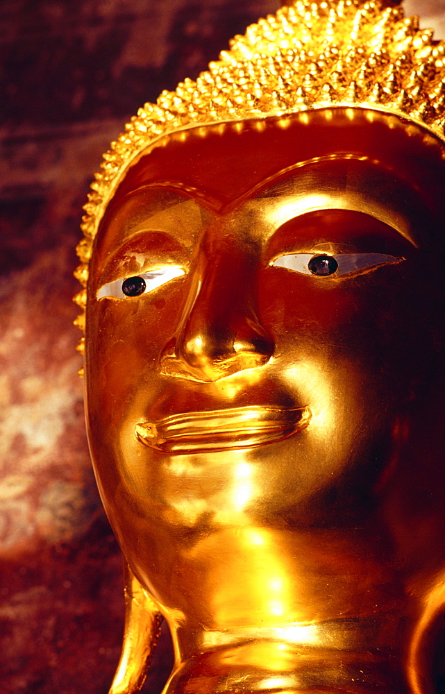 Thailand, Bangkok, Wat Suthat, closeup detail of golden Buddha statue, memorial for deceased