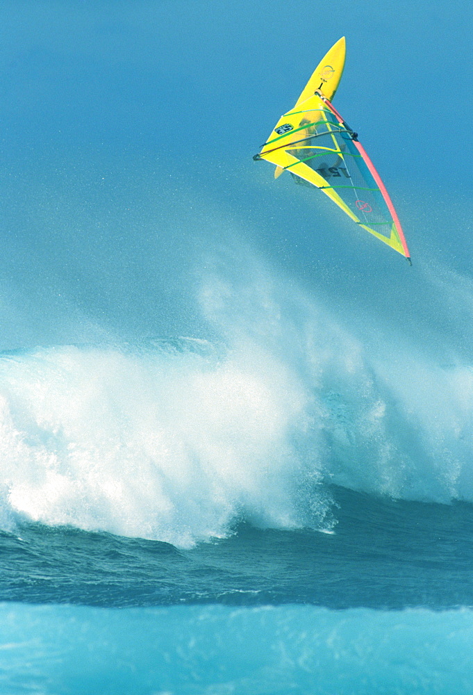 Hawaii, Maui, Ho'okipa, Alex Aguera airborne over huge wave,