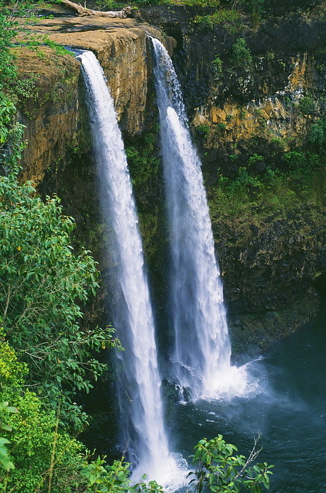 Hawaii, Kauai, Wailua Falls, 80 foot high waterfall cascading into deep pool.